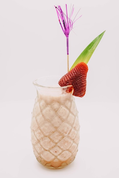 Pina colada cocktail served in a pineappleshaped glass