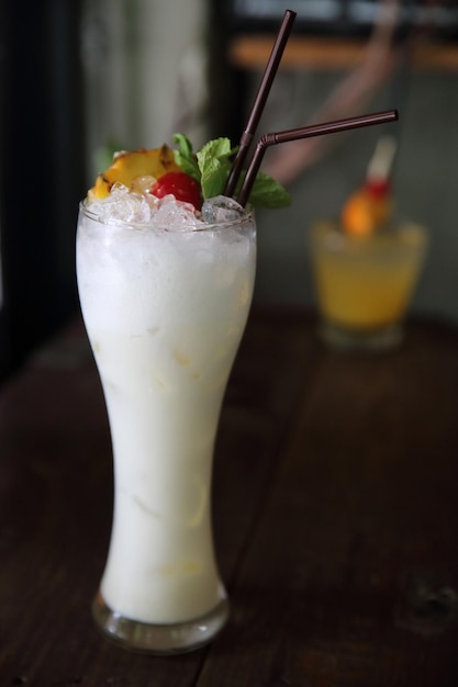 Pina colada cocktail with pineapple and cherry fruit