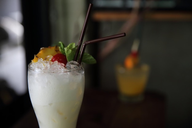 Pina colada cocktail with pineapple and cherry fruit