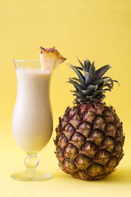 Piña colada cocktail on yellow