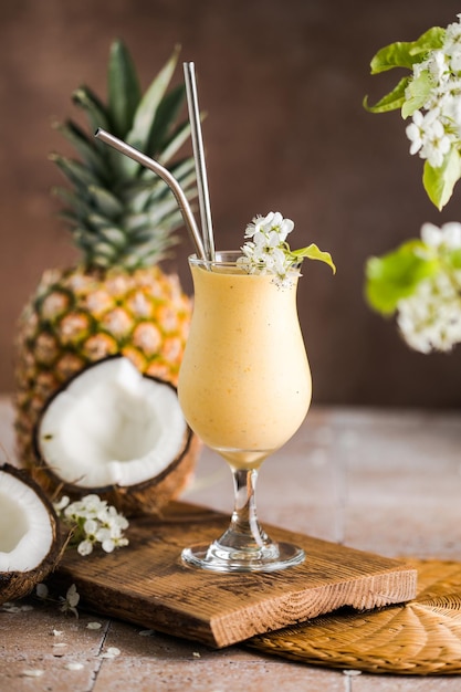 pina colada pineapple cocktail or lassi on a rustic wooden table