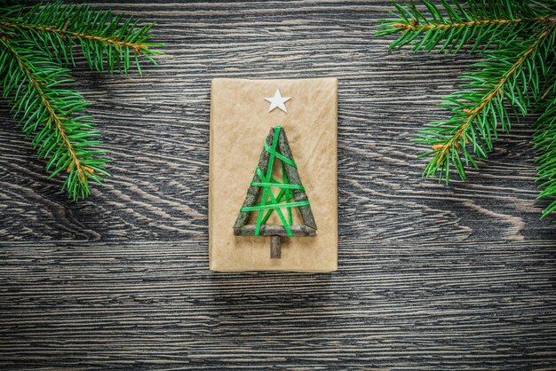 Pine branch gift box on wooden board