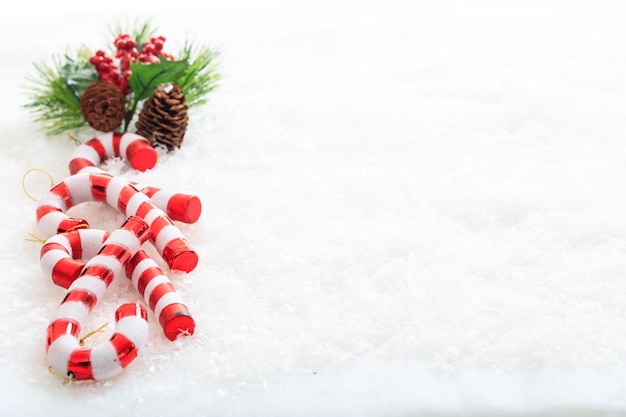 Pine cones and candy canes on snow