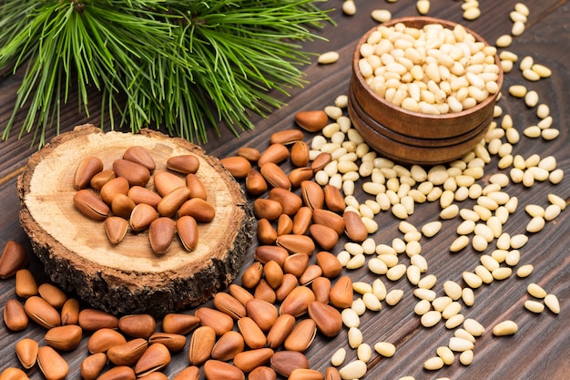 Pine nut kernels in wooden box and on table