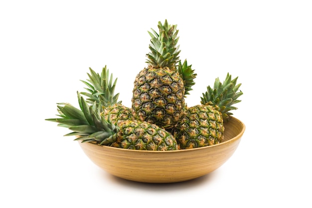 Pineapple in a bowl isolated om white.