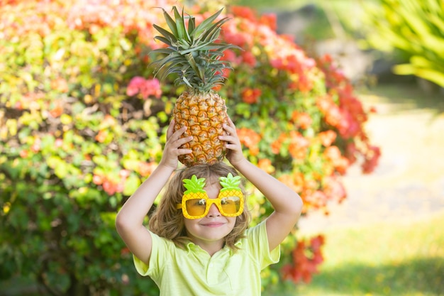 Pineapple child boy and pineapples on summer vacation.