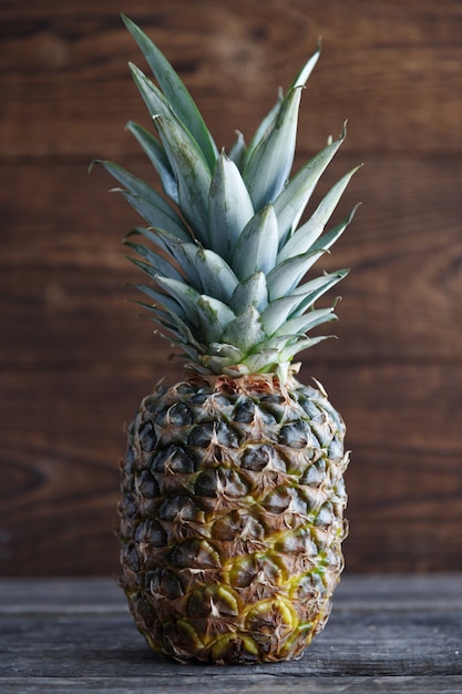 Pineapple close-up on a wooden background. Tropical fruit.