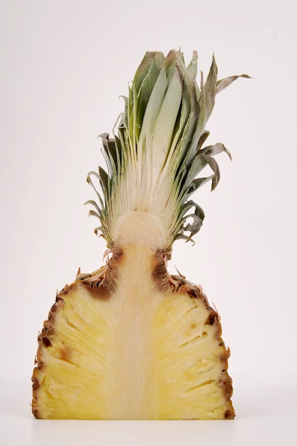 Pineapple cut in half on white background