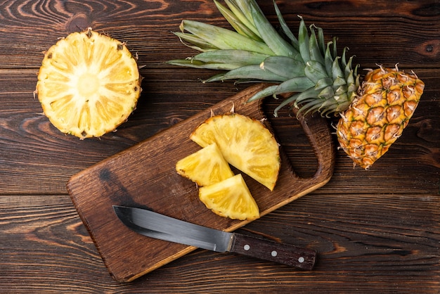 Photo pineapple on dark wooden.