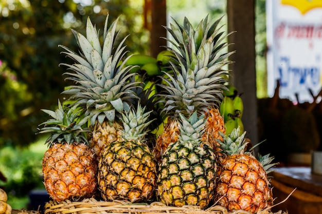 Pineapple fruit on wood table for sale.