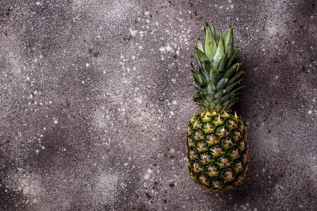 Pineapple on gray concrete background