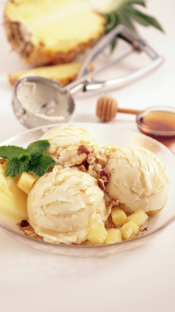 Pineapple ice cream topping with honey and crushed almond