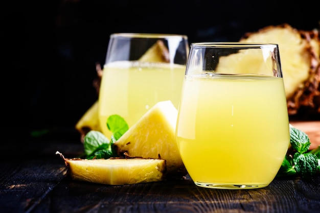 Pineapple juice dark background selective focus