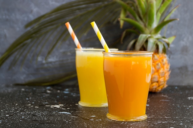 Pineapple juice in a jar with a straw.