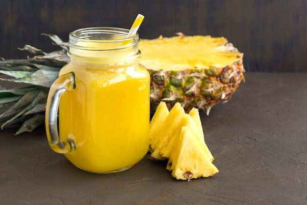 Pineapple juice in a jar with a straw