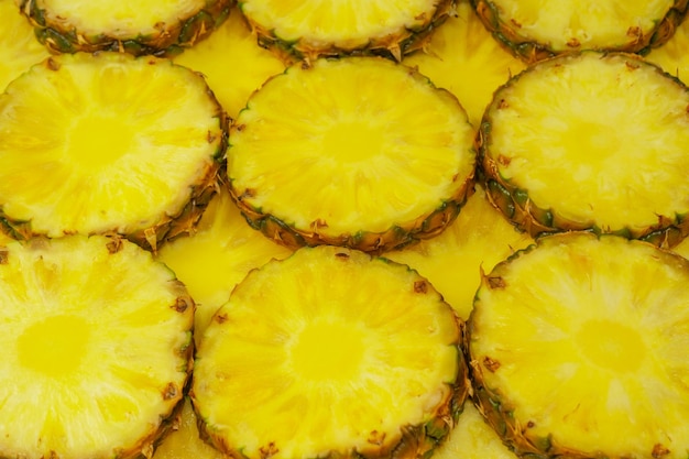 Pineapple juicy yellow slices as a background