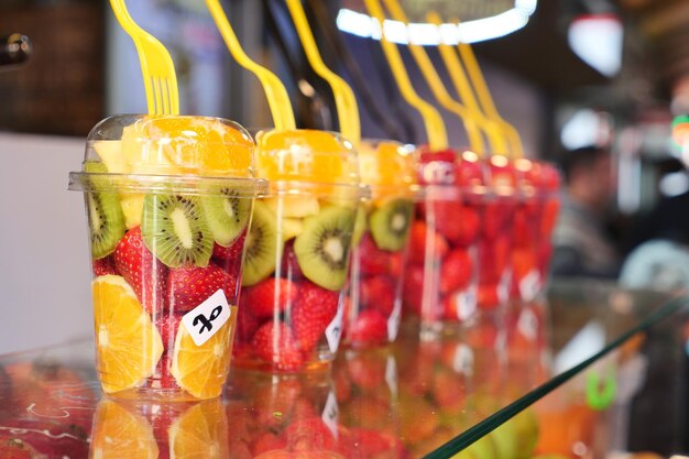 Pineapple kiwi and strawberries in plastic container selling at shop