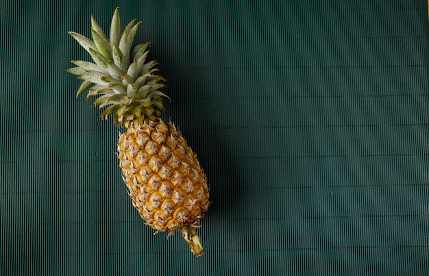 Pineapple on paper green background