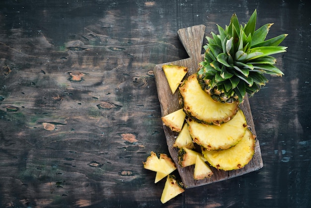 Pineapple Sliced pineapple on a wooden background Top view Free copy space