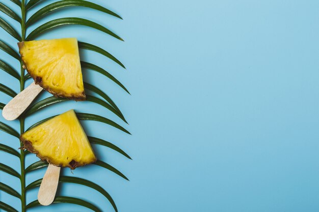 Pineapple slices and palm branch