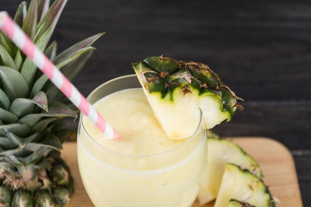 pineapple smoothie on wood background