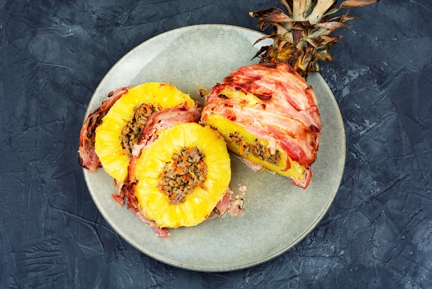 Pineapple stuffed with meat on a plate