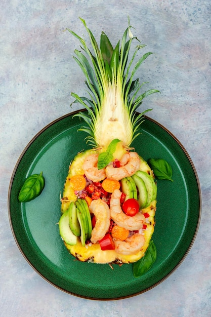 Pineapple stuffed with prawn rice and avocado