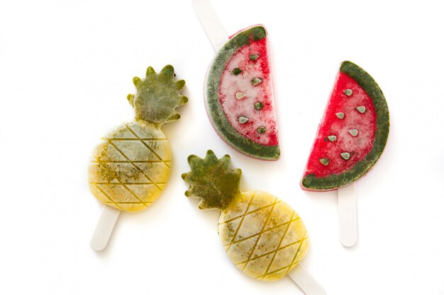 Pineapple and watermelon popsicles isolated on white, top view