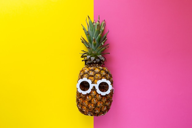 Pineapple in White Sunglasses on the Colorful Background, Creative Summer Concept