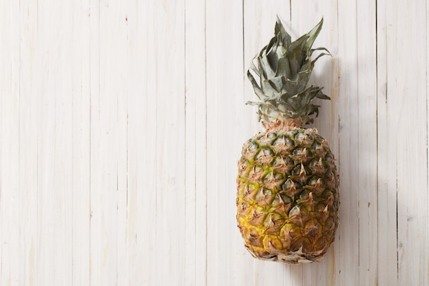 Pineapple on white wooden table