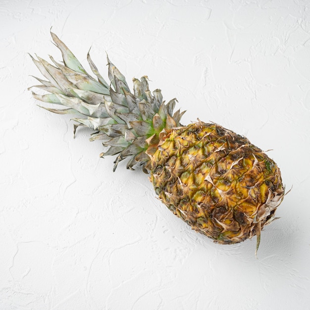 Pineapple whole set, on white stone table background, top view flat lay, square format