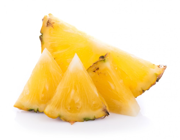 Pineapple with slices on white wall