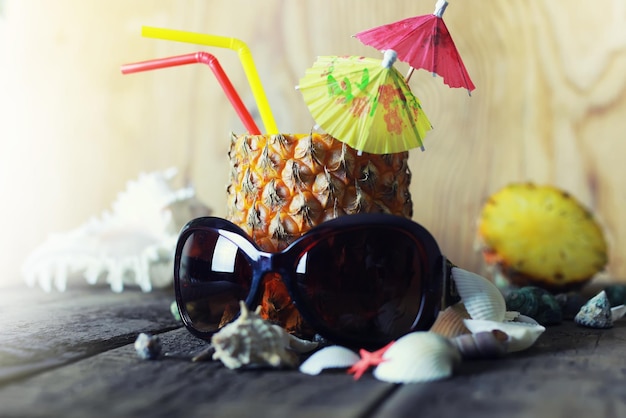 Pineapple with straw and cocktail umbrella