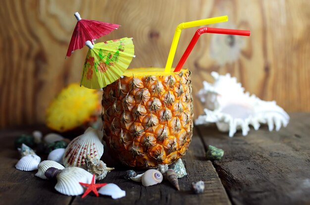 Pineapple with straw wooden background