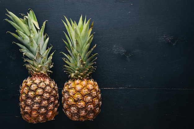 Pineapple on a wooden background Top view Free space for text