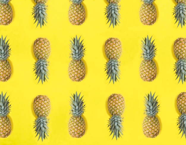 Pineapple on the yellow background Flat lay Pattern Top view