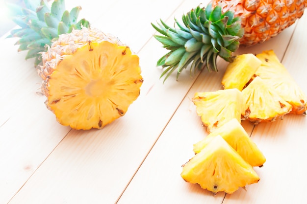 Pineapples cut and slice on wooden table