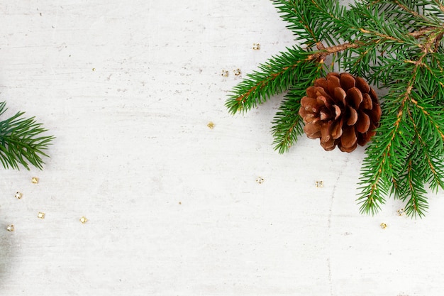 Pinecone and fir branch on wooden table