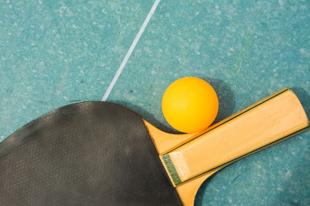 Ping pong paddles and ball on retro  blue