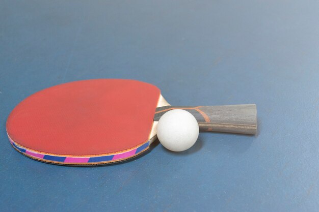 ping pong rackets and balls on table