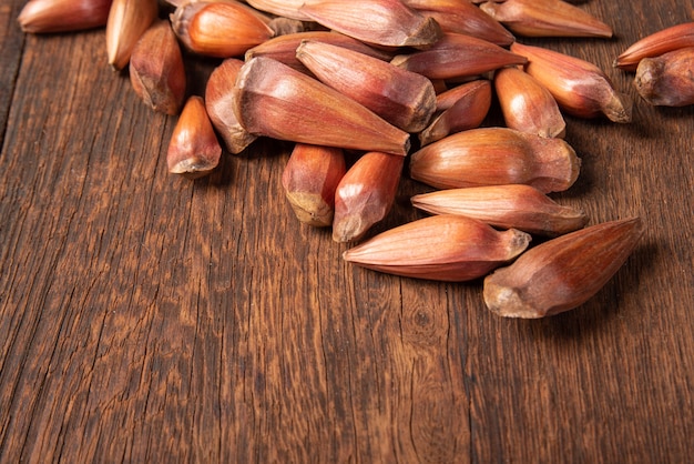 Pinhao, pinion, pine fruit, Brazilian Araucaria tree, on rustic wood