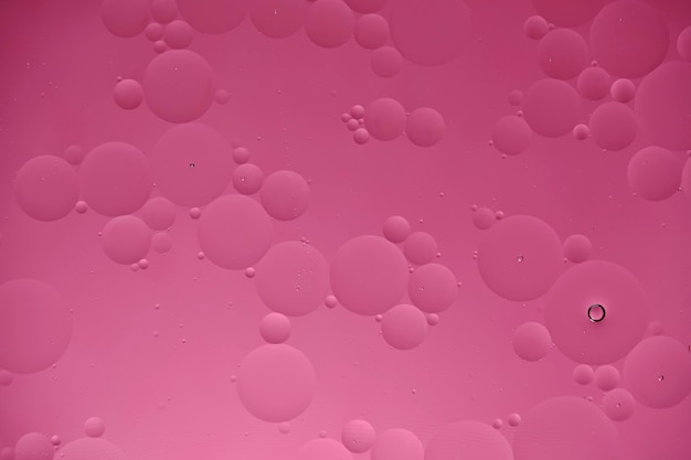 Pink abstract background with oil circles streaks and gradient