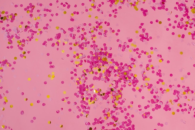 Foto sfondo di coriandoli astratto rosa con un sacco di cerchi che cadono elemento decorativo festivo di tinsel per il design