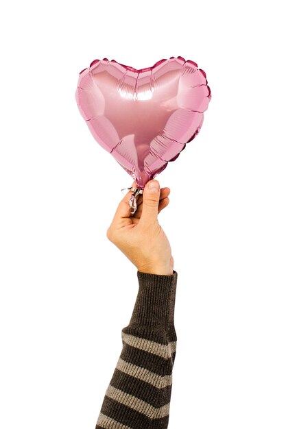 Photo pink air balloon held by a hand on an isolated.