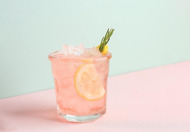 Pink Alcoholic Rose Lemon Beverage or Lemonade Cocktail with Rosemary and Lemon Slice