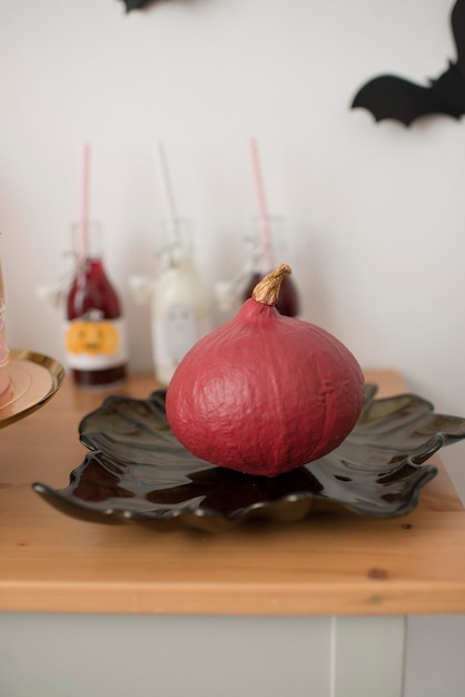 Pink autumn pumpkin in the interior of the room.