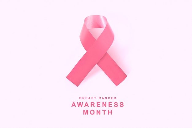 Pink awareness ribbon on pink background. Breast cancer awareness