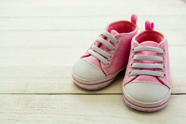 Pink baby girl shoes,  Newborn, motherhood, pregnancy concept with copy space.