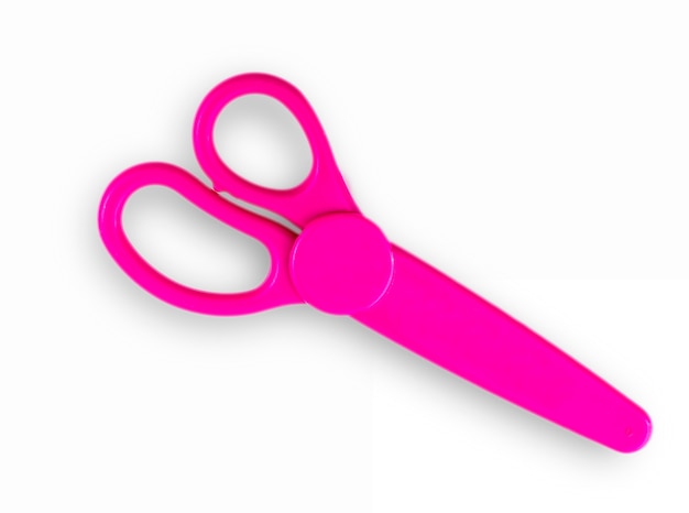 Photo pink baby scissors cut out on a white background. view from above.