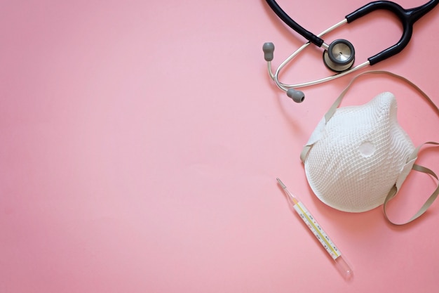 Pink background about pandemia of corona virus with stethoscope